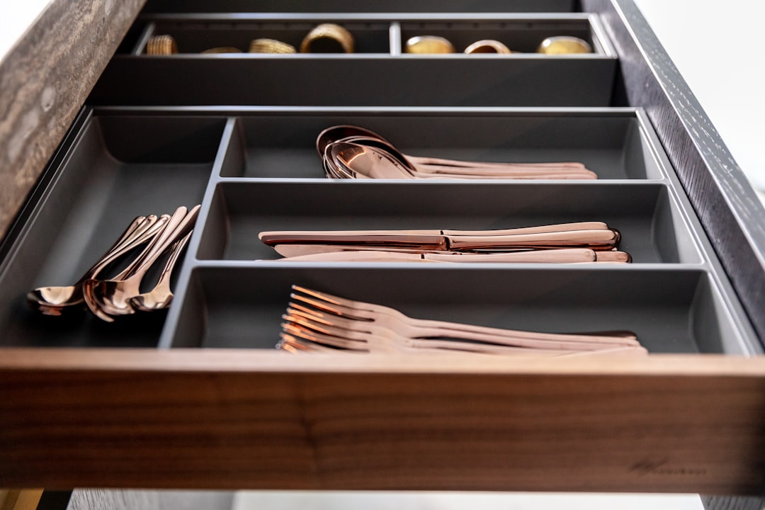 Photo by Orgalux a drawer filled with lots of different types of utensils