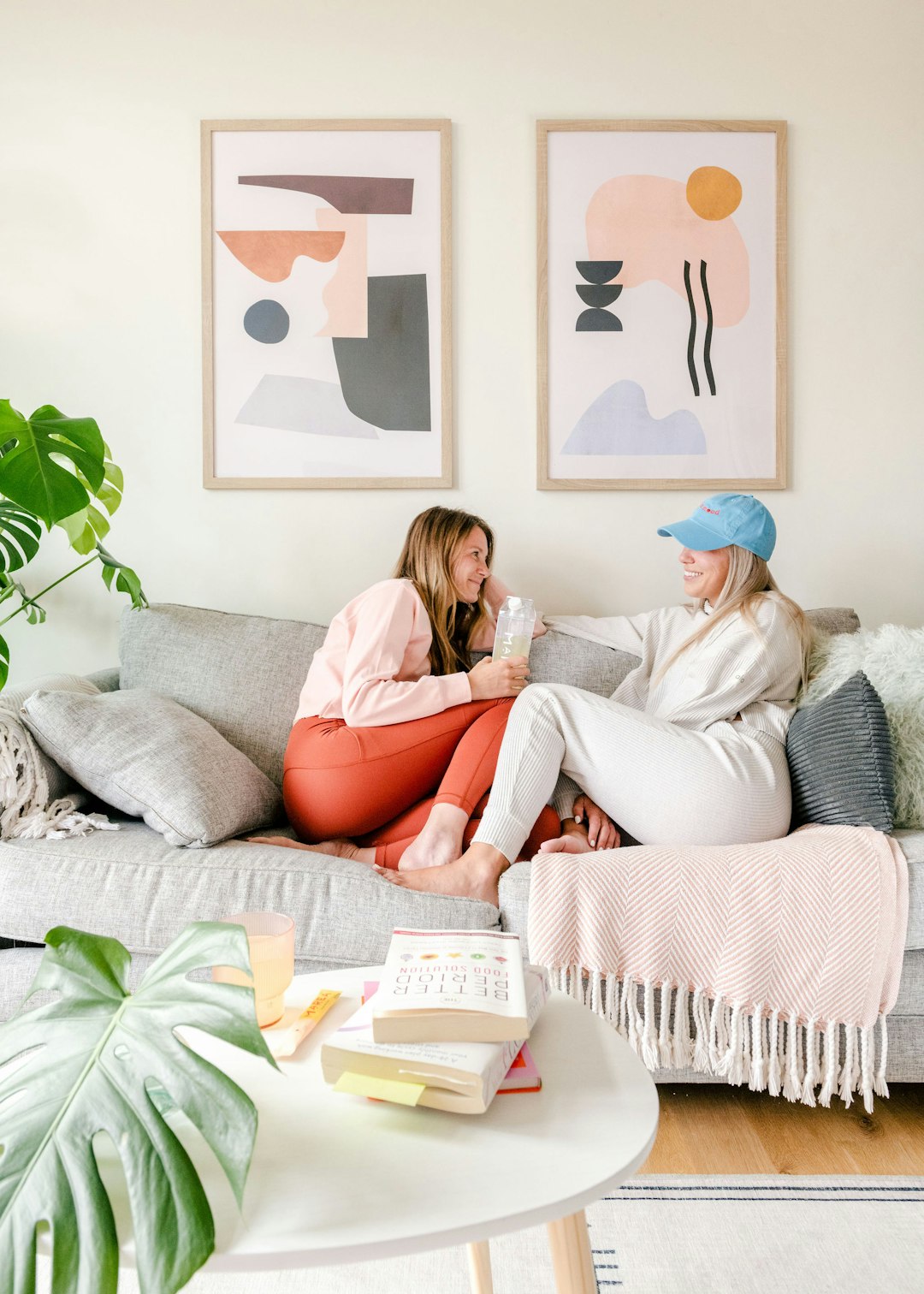 Photo by Marea Wellness two women sitting on a couch in a living room